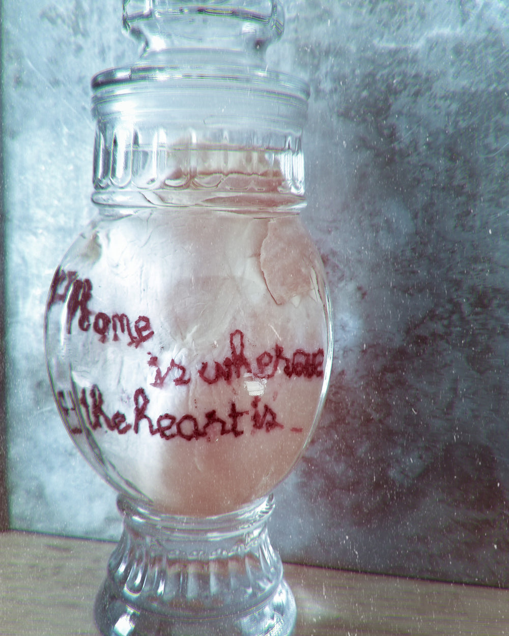 Real fluid preserved wet specimen heart embroidered with "Home is where the heart is" in vintage decanter. Part of organ embroidery series.
